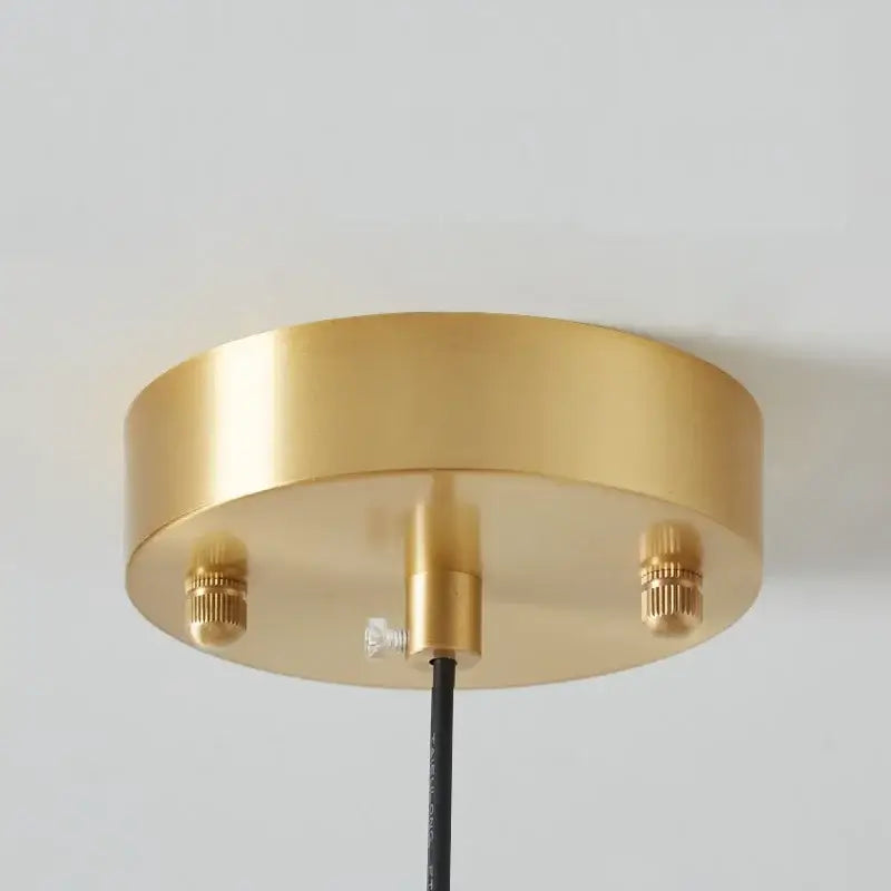 DecorBites™ copper pendant light features a gold-colored circular ceiling fixture with a brushed metal finish and adjustable screws