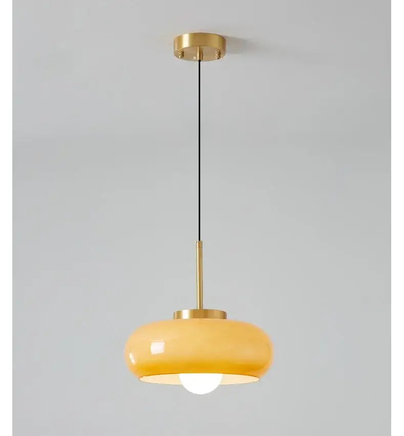 DecorBites™ copper pendant light with warm amber glass shade and brass-finished metal components for modern decor