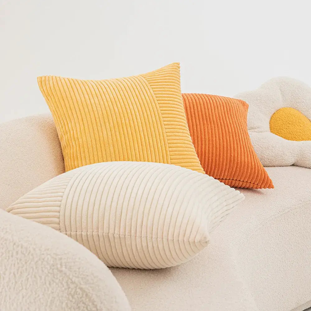 Yellow corduroy pillow cover with vertical ribbed texture and orange accent panel from decorbites corduroy striped patchwork set