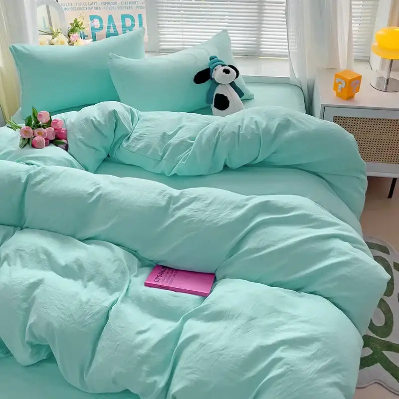 Decorbites cotton bedding set with mint green duvet cover and pillowcases featuring plush stuffed dog on bed