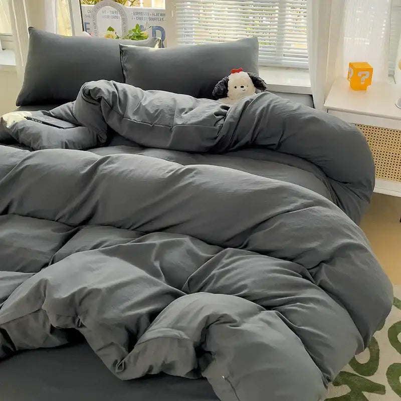 A plush dark gray cotton bedding set with visible stitching lines featuring a soft quilted duvet cover texture