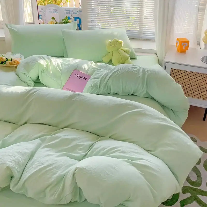 Soft mint green quilted cotton bedding set with duvet cover plush pillowcases and matching stuffed frog toy by decorbites