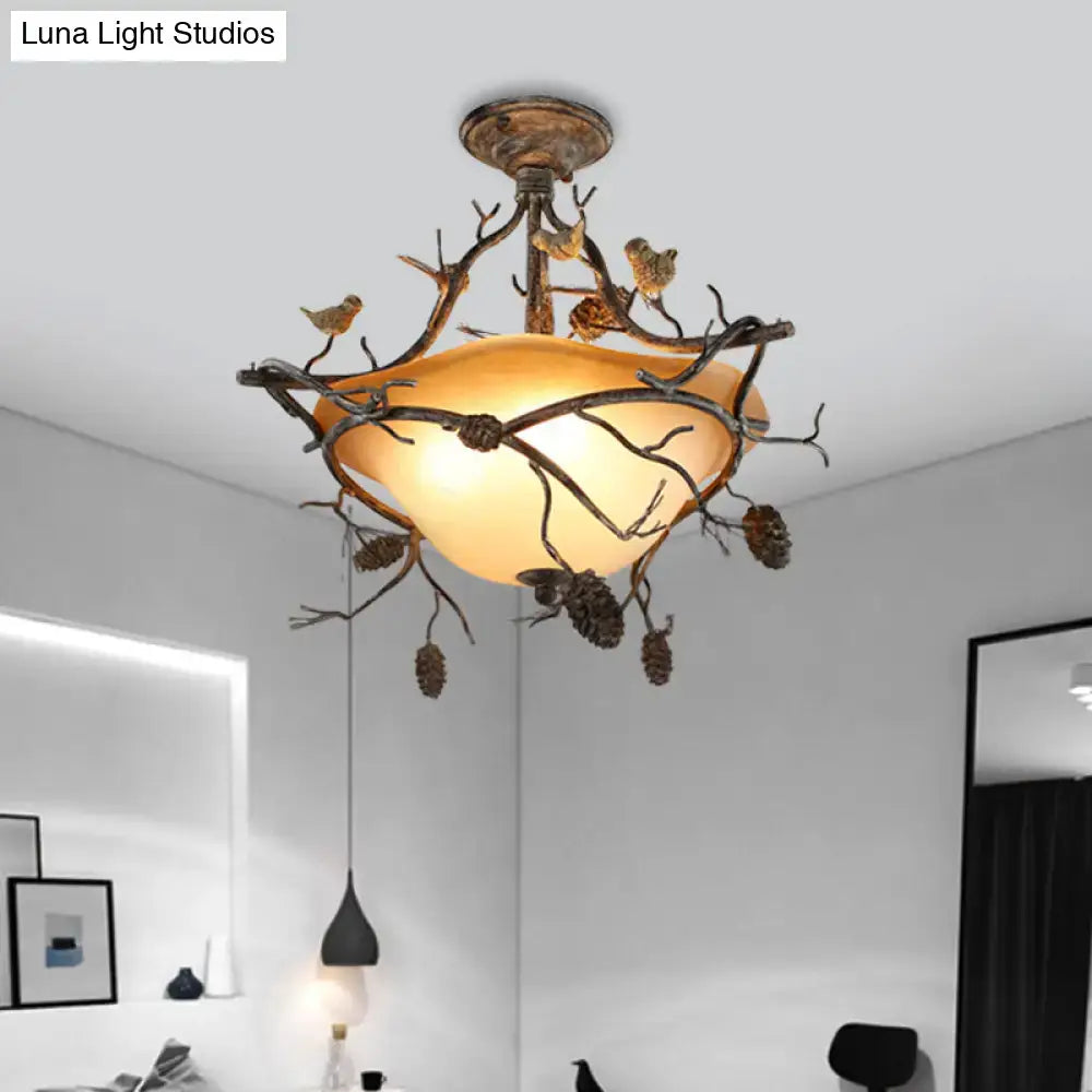 Antique bronze finished decorbites semi flush ceiling light with branch pinecone design and amber bowl semi shade