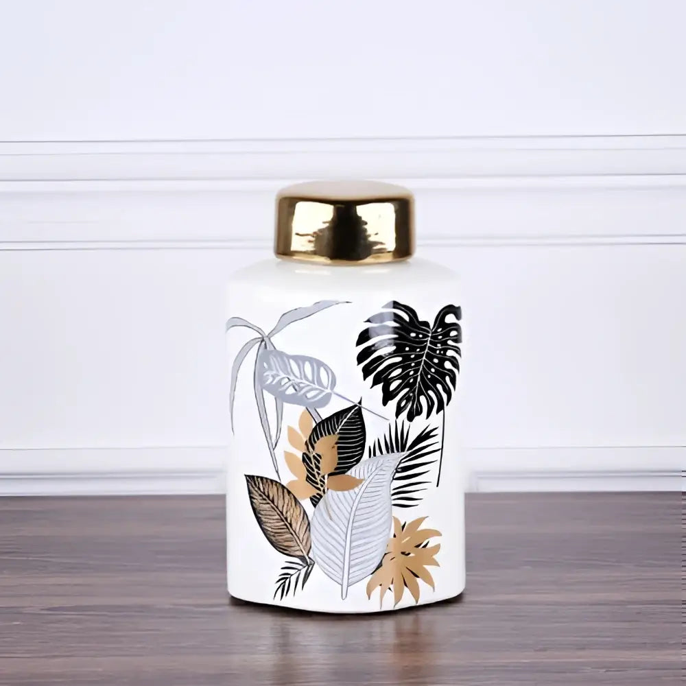 White ceramic jar with gold lid and tropical leaf decals for dining room decor by decorbites country ceramic