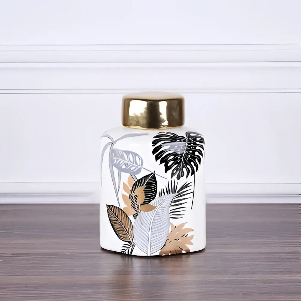 Decorbites country ceramic white jar with gold lid featuring black gray and tan tropical leaf pattern for dining decor