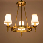 Decorbites country fabric brass chandelier with three warm-toned fabric shades for bedroom lighting