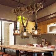 Rustic industrial style bamboo hanging lamp with three cage glass bulbs and thick beige hemp rope for restaurants