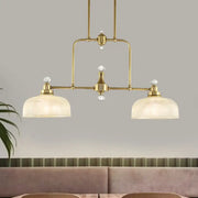 Brass-finished industrial pendant light kit with clear prismatic glass shades and crystal accents for kitchen island lighting