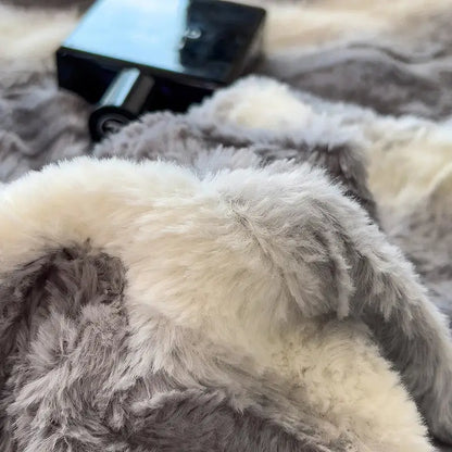 A plush two-toned gray and cream faux fur blanket from decorbites cozy faux bedding set for bedroom comfort