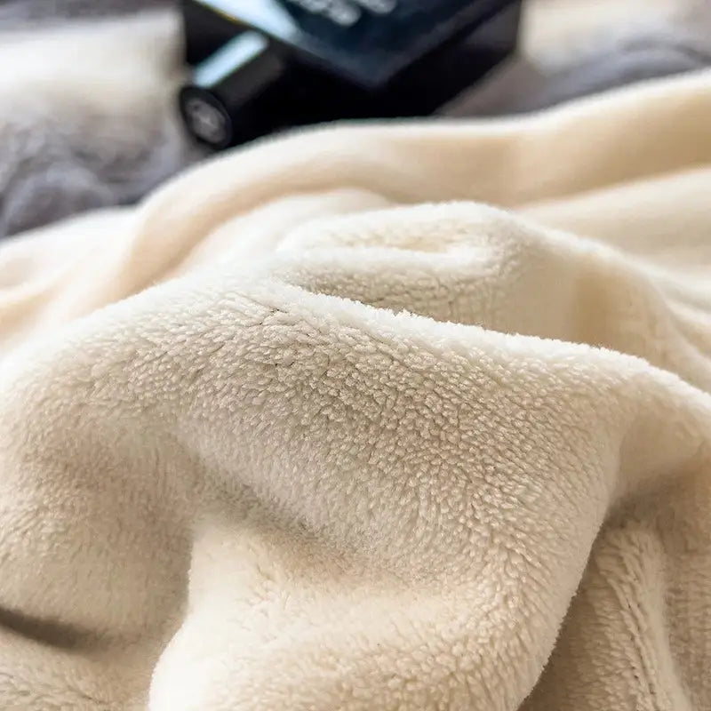 Cream-colored plush fleece blanket with soft textured surface as part of decorbites cozy faux fur gray white bedding set
