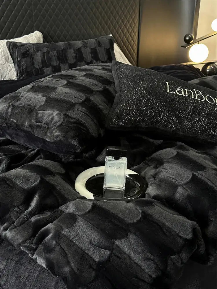 A sleek glass perfume bottle with black cap on a tray complements decorbites cozy faux rabbit fur bedding set black and grey