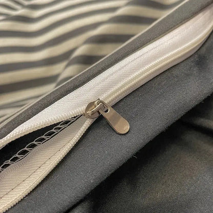 A silver-toned zipper with metallic pull tab on the seam of a light green nordic plaid 1pc duvet cover from decorbites