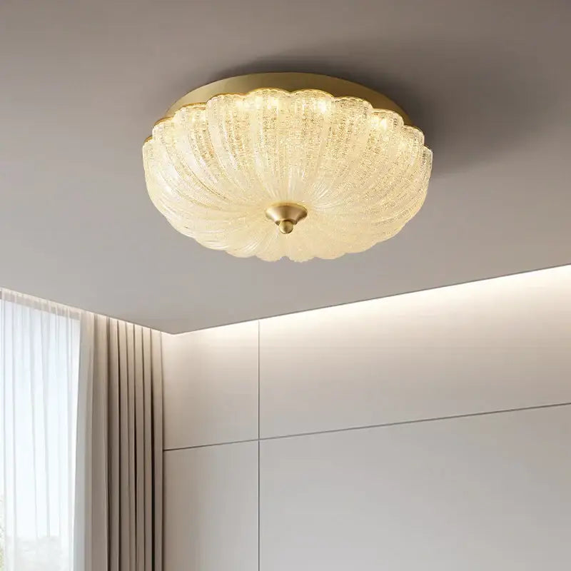 A golden-toned decorbites cream air ceiling lamp with ribbed glass and a scalloped textured translucent finish