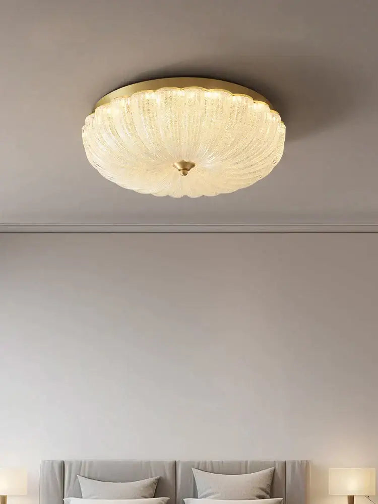 Decorbites cream air ceiling lamp with a gold ribbed frosted glass frame designed for bedroom lighting