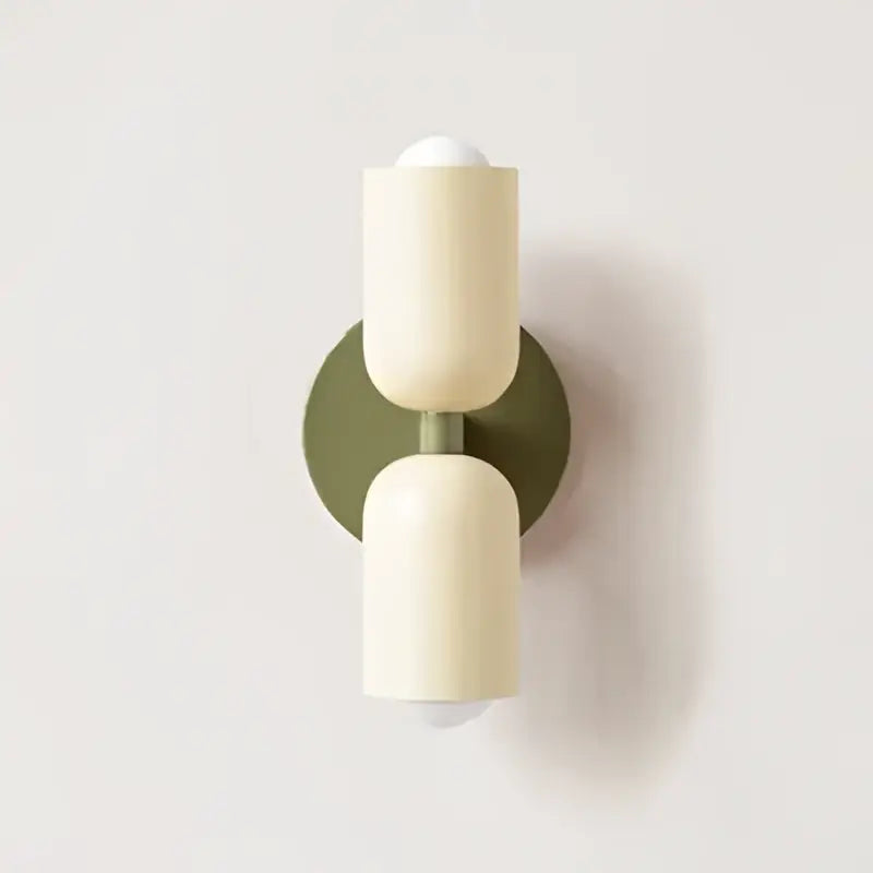 Cream double head wall lamp by Decorbites featuring cream cylindrical sconces with matte finish and olive green backplate