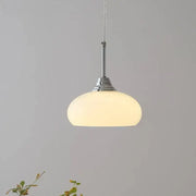 A decorbites cream glass oval pendant light with frosted glass shade and polished chrome hardware for dining room use