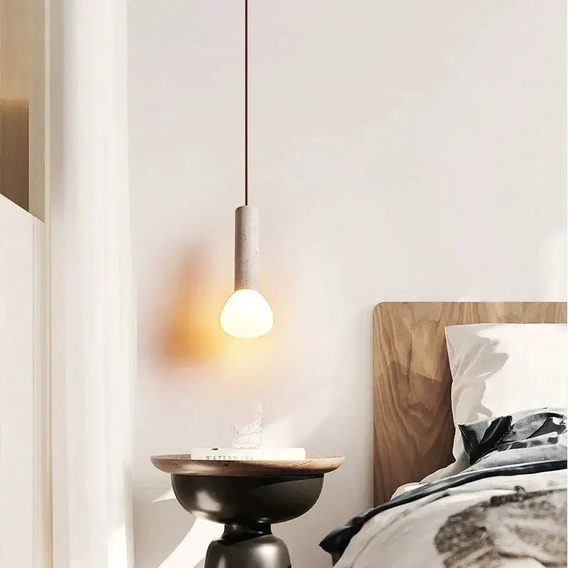 Concrete pendant light with cylindrical cream shade and warm bulb in decorbites cream style living room chandelier