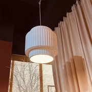 A modern decorbites cream wind led chandelier with a cream fluted cylindrical pendant light and warm glowing illumination