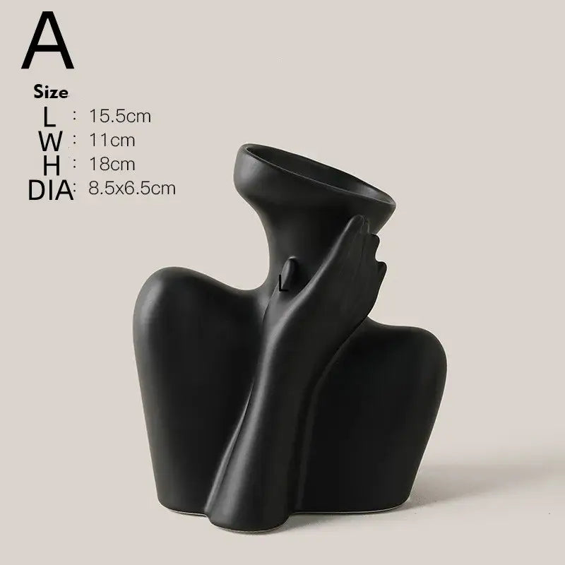 Black ceramic human vase with abstract flowing form holding its own head for modern home decor by DecorBites