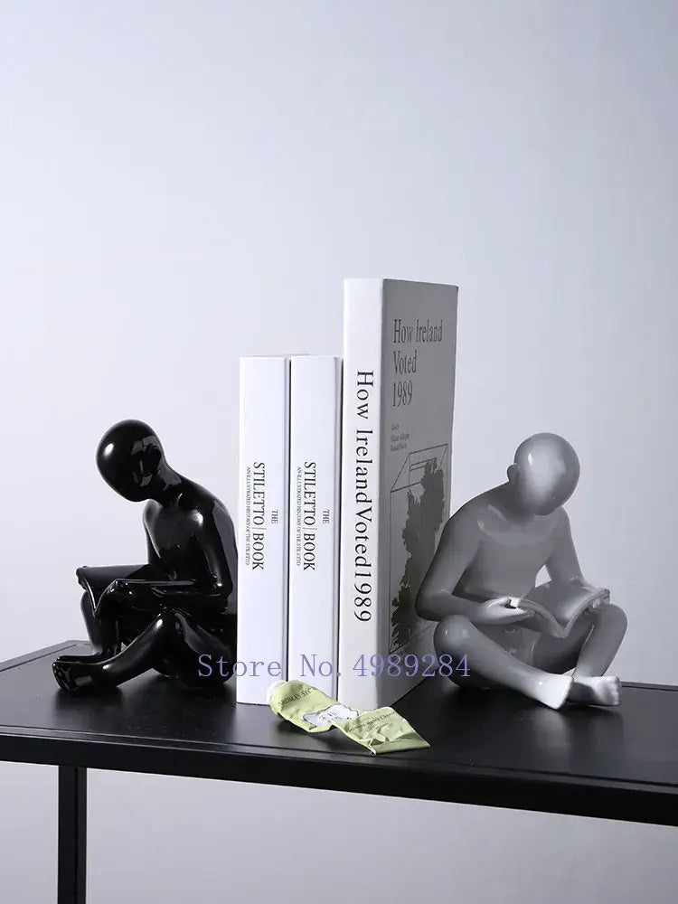 Black and silver glossy ceramic bookends shaped like seated human reading figures by decorbites creative ceramics