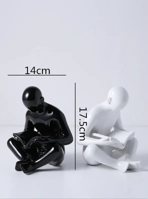 Black and white glossy resin creative ceramics sculpture by decorbites creative featuring abstract seated figures with books