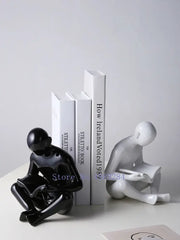 Black glossy ceramic figurine of a seated person reading from decorbites creative ceramics for living room decor