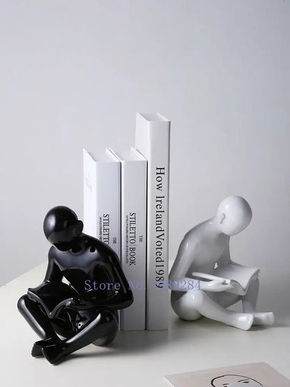 Black glossy ceramic figurine of a seated person reading from decorbites creative ceramics for living room decor