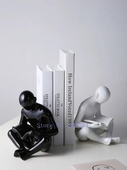 Black glossy ceramic figurine of a seated person reading from decorbites creative ceramics for living room decor