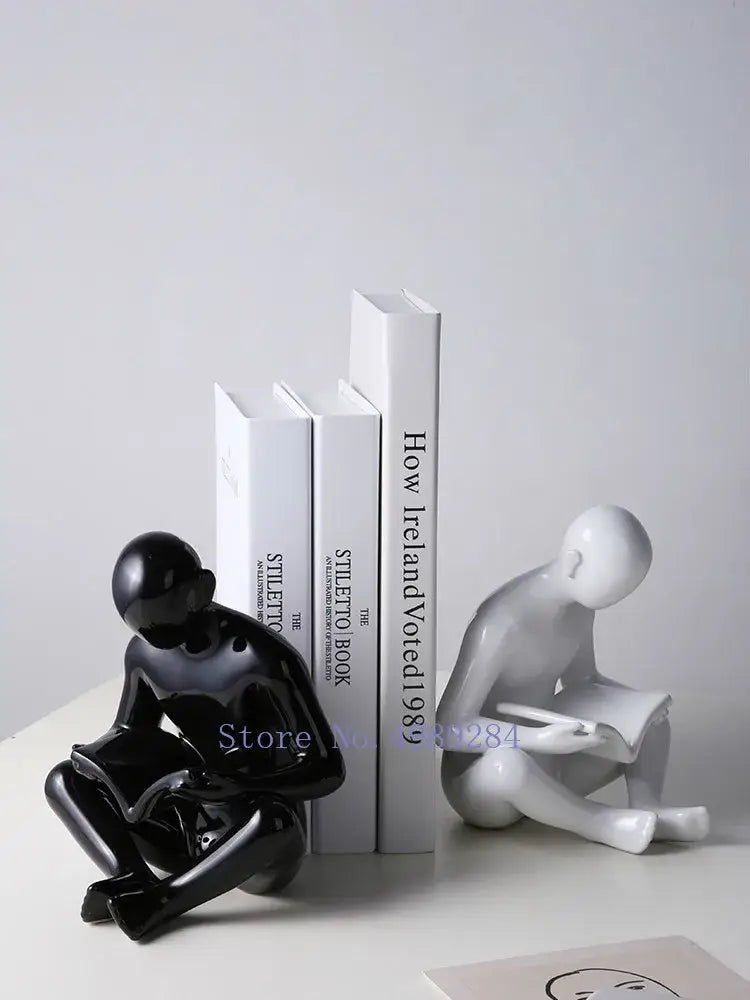 Black glossy ceramic figurine of a seated person reading from decorbites creative ceramics for living room decor