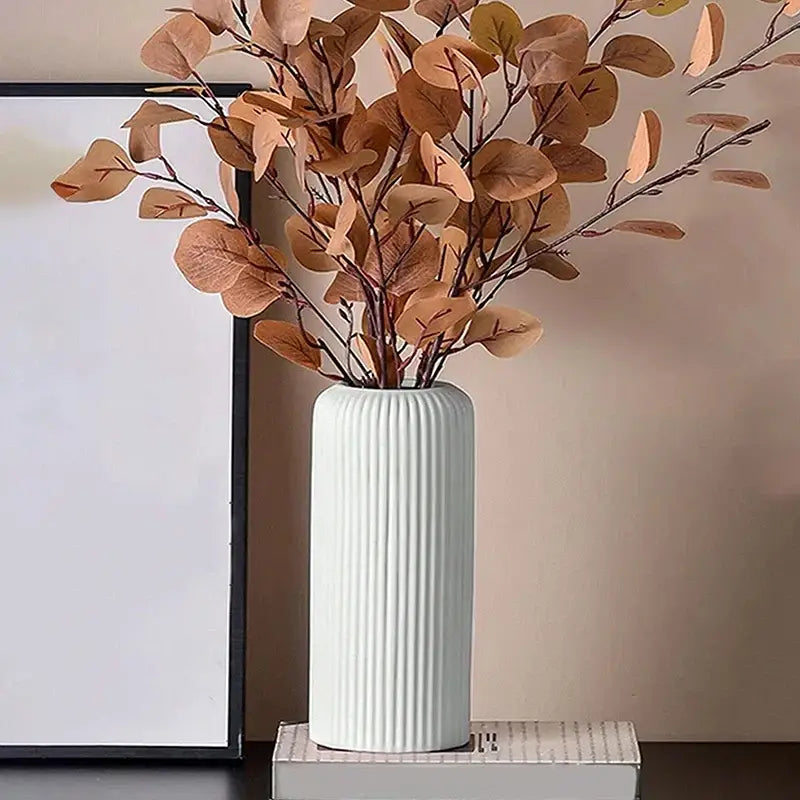 Decorbites™ creative striped plastic flower vase in white with vertical ridges holding dried brown leaves for floral arrangements