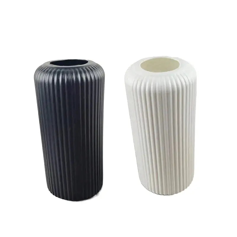 Two DecorBites™ creative striped plastic flower vases with vertical ribbed texture in matte black and off-white for floral arrangements