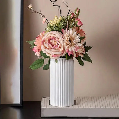 White ribbed ceramic flower vase from DecorBites™ holding pink and cream artificial floral arrangements