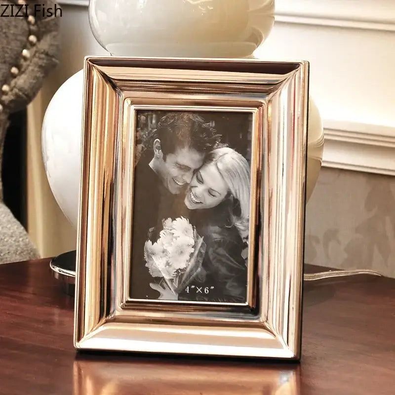 A sleek rose gold metallic photo frame with ribbed design and beveled edges from decorbites crocodile leather modern collection