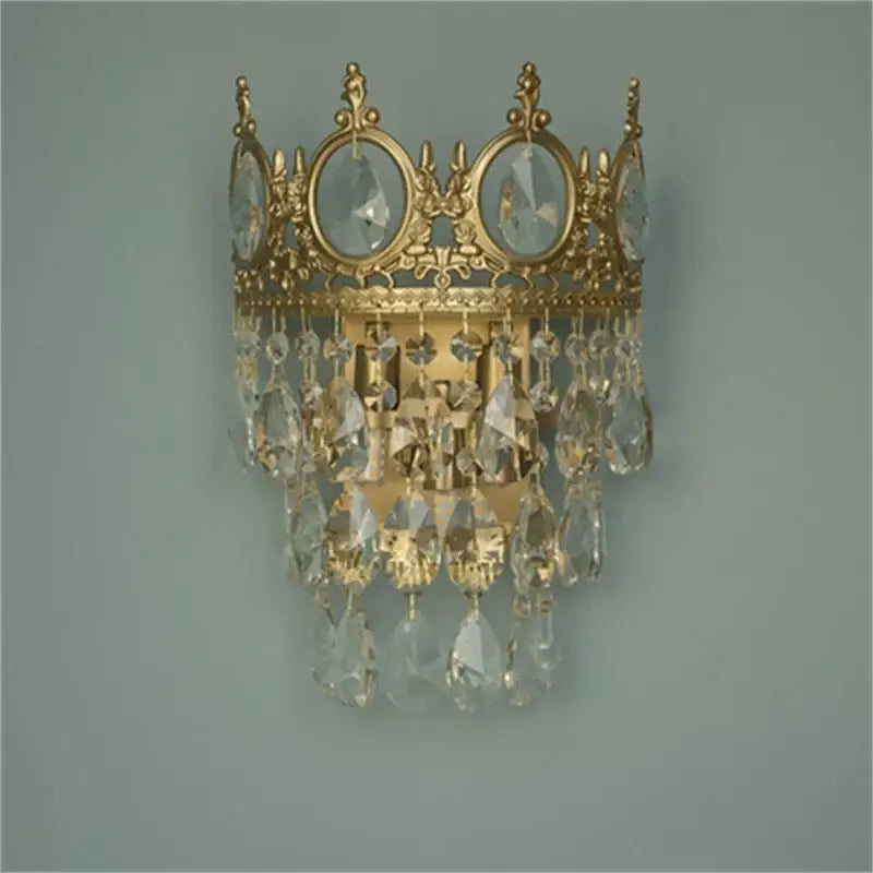 Gold-toned crown crystal chandelier wall sconce by decorbites featuring dangling crystal droplets for bedroom decor