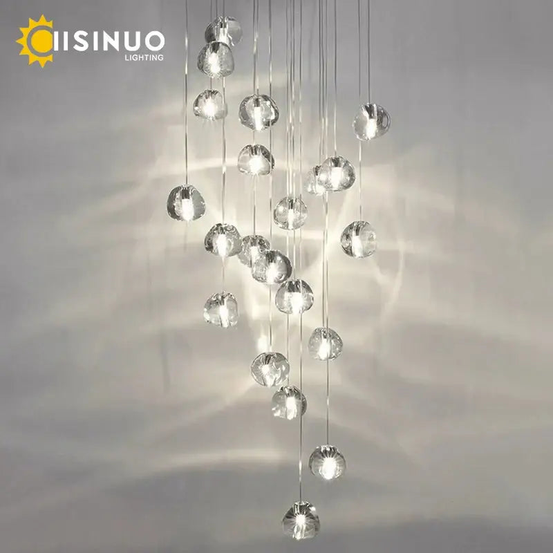 A modern decorbites crystal ball chandelier with clear faceted spherical bulbs for dining room staircase lighting