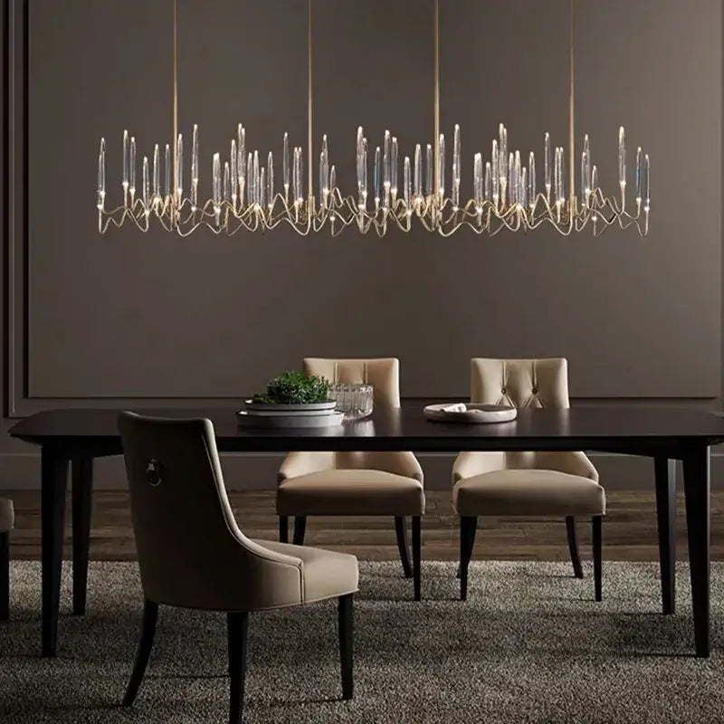 Modern decorbites crystal branch chandelier with slender transparent glass candles and gold-toned metal frame for dining room lighting
