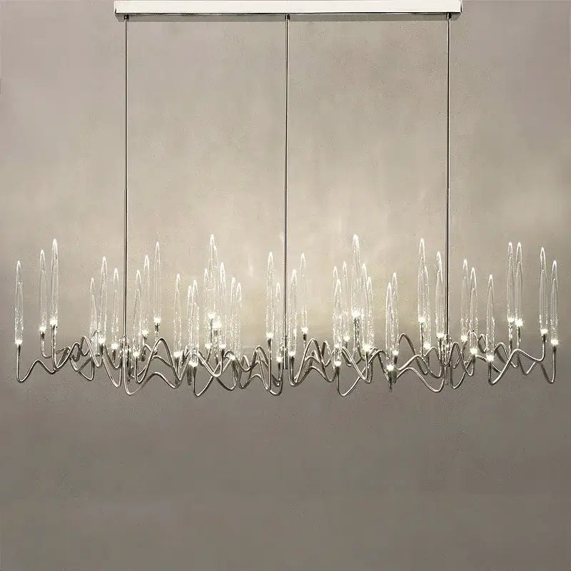Modern decorbites crystal branch chandelier in gold with chrome-finished wave-like arms and clear glass candle bulbs
