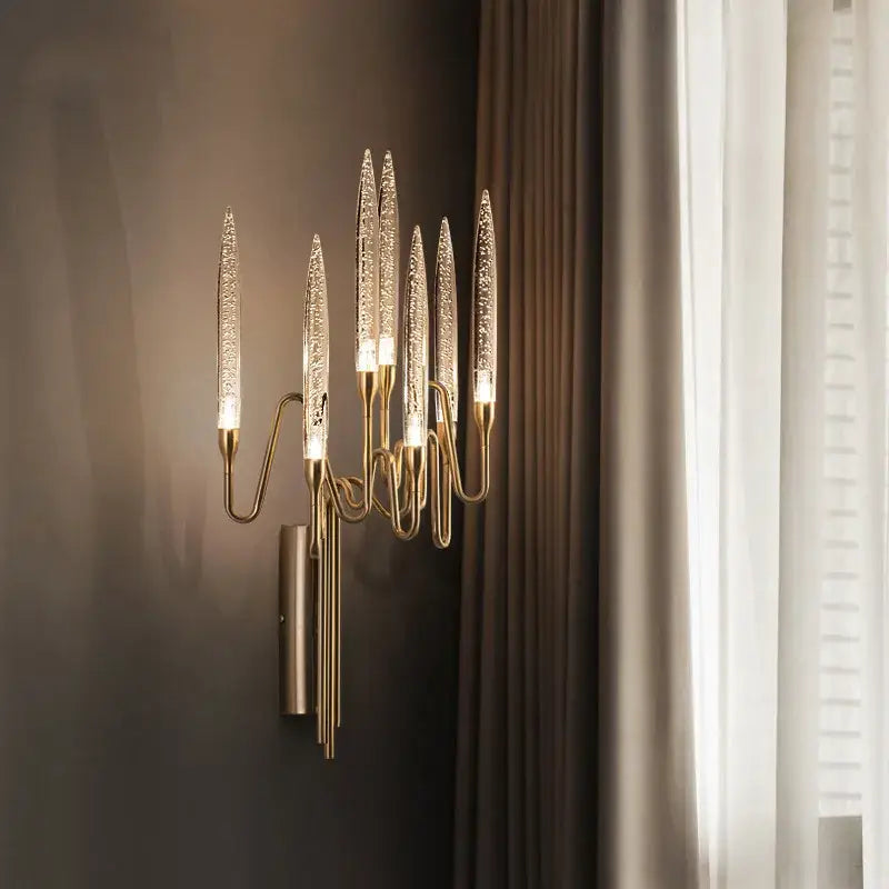 Gold-toned decorbites crystal branch chandelier with six textured glass arms emitting warm light for dining room use
