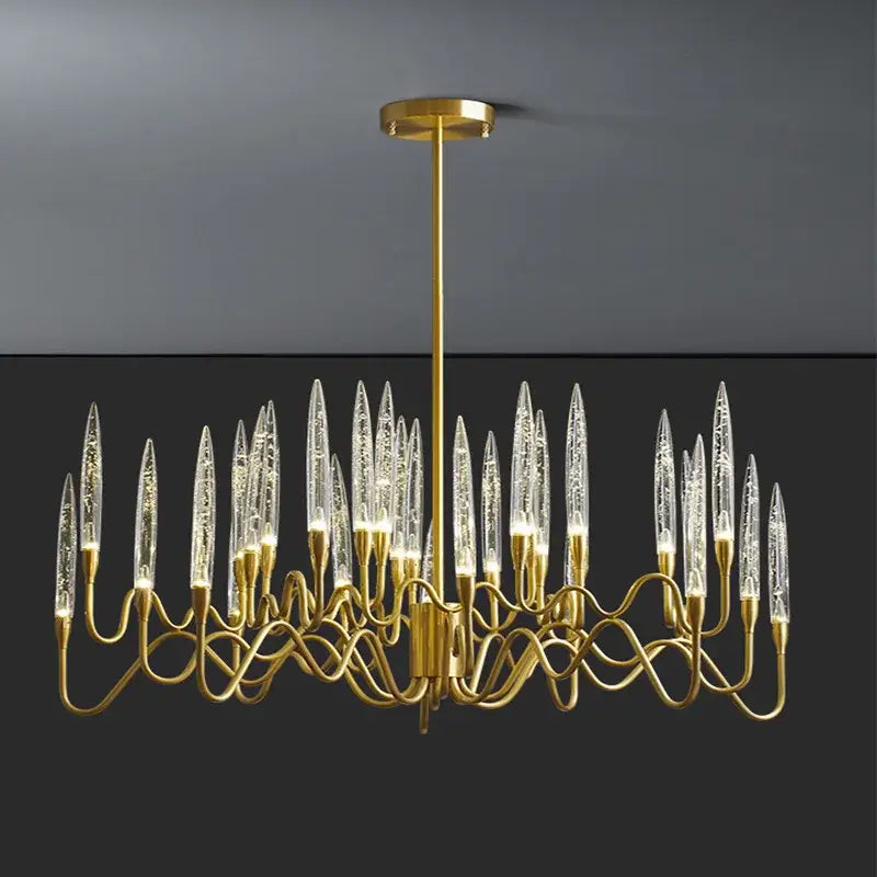 Gold-toned decorbites crystal branch chandelier with clear icicle glass elements and twisted metal arms for dining room use