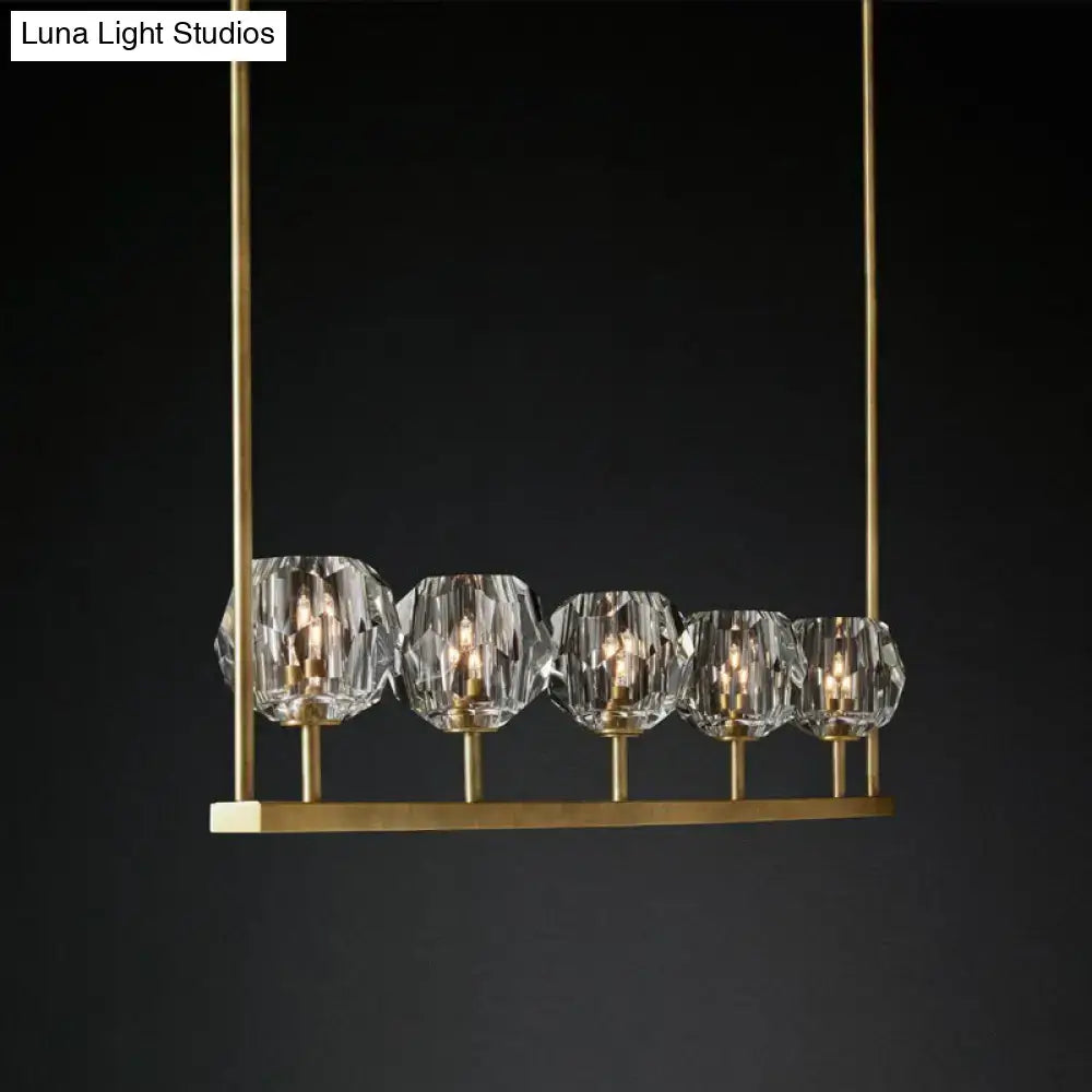 Decorbites™ crystal brass island light with five faceted crystal globe shades on a brass ceiling suspension lamp
