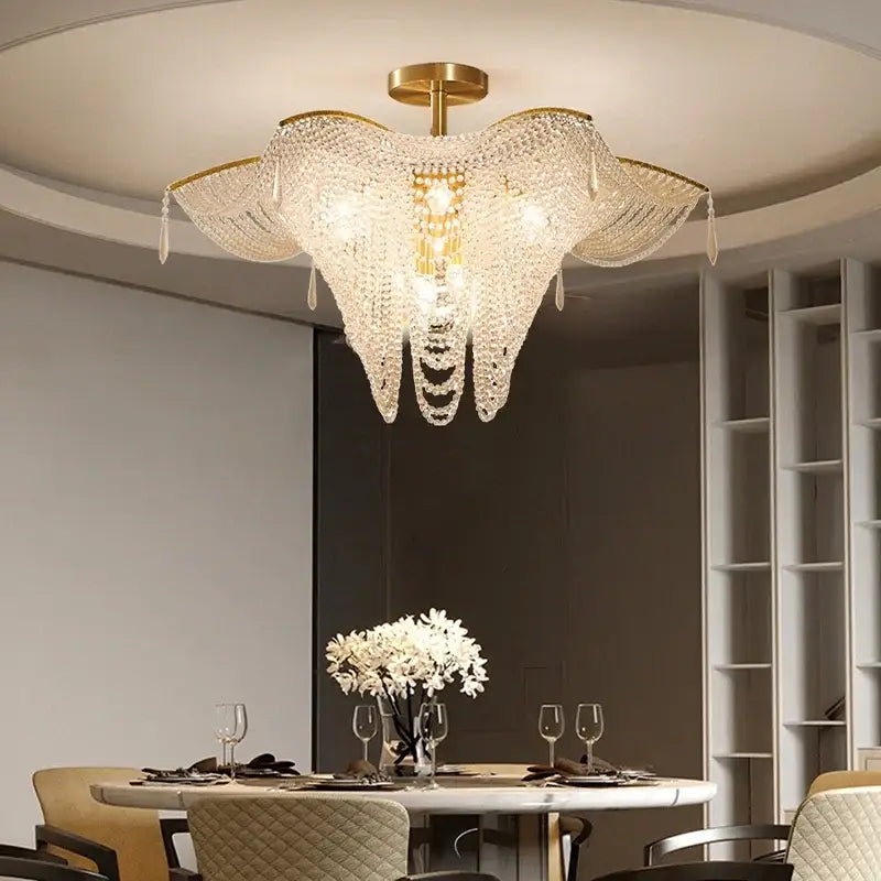 A gold-toned decorbites crystal butterfly chandelier with cascading crystal droplets for living room lighting