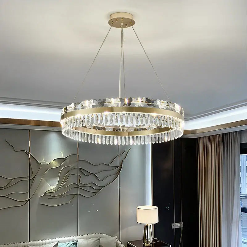 A modern circular gold chandelier with clear crystal droplets and butterfly embellishments for butterfly living room by decorbites crystal butterfly