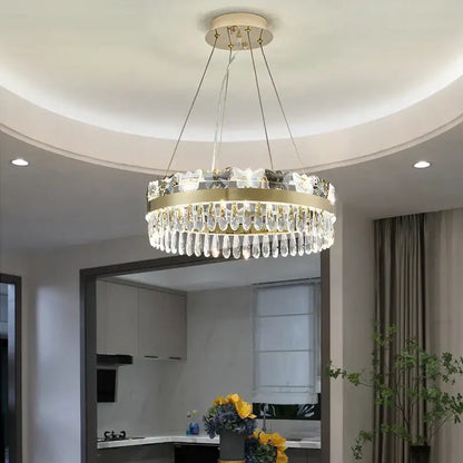 A modern decorbites crystal butterfly living gold chandelier with a circular frame and clear crystal droplets
