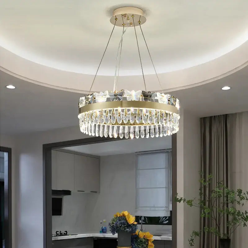 A modern decorbites crystal butterfly living gold chandelier with a circular frame and clear crystal droplets