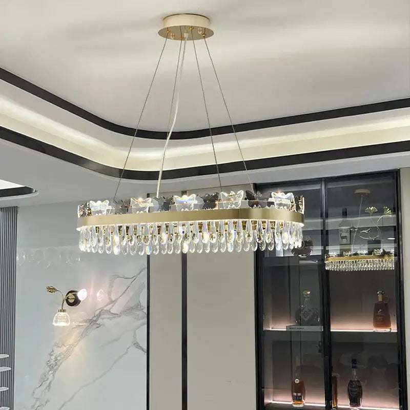 Gold-toned circular chandelier with dangling crystal droplets and butterfly-shaped accents for butterfly living room decorbites crystal butterfly luxury lighting