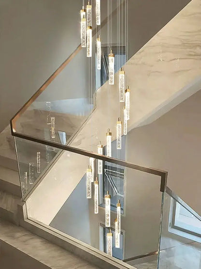 Modern nordic decorbites crystal ceiling chandelier with slender cylindrical glass pendants and gold-toned metal caps