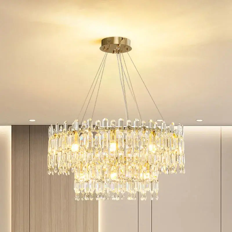 A decorbites crystal ceiling chandelier with gold-toned mount and cascading clear glass prisms for indoor luxury lighting