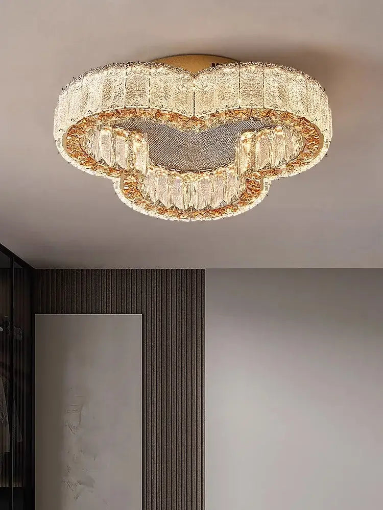 A modern cloud-shaped decorbites crystal ceiling lamp with clear crystals and gold accents for living room and bedroom