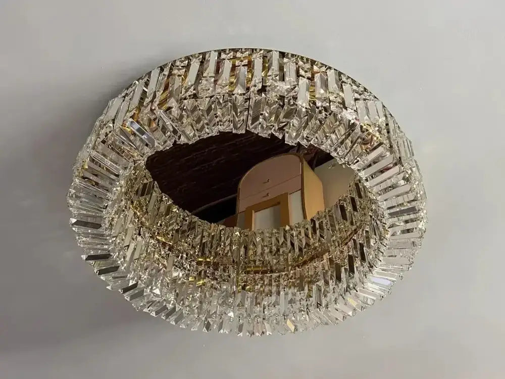 Circular mirror framed with clear faceted crystal prisms in decorbites crystal ceiling lamp for modern living spaces