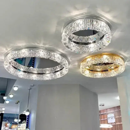 Three modern chrome and gold decorbites crystal ceiling lamps with double-ring clear crystal design for luxe living rooms